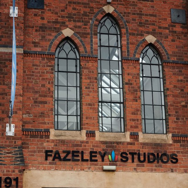 Fazeley Studios logo on old-style building. Banners above the entrance advertise unique event space to hire.