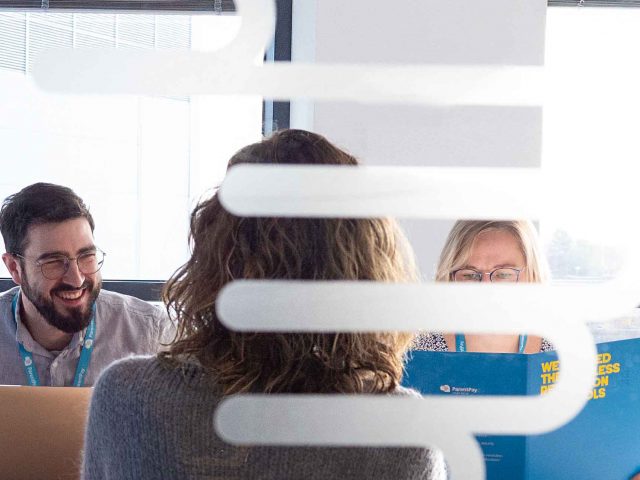 Meeting in a glass windowed board room.