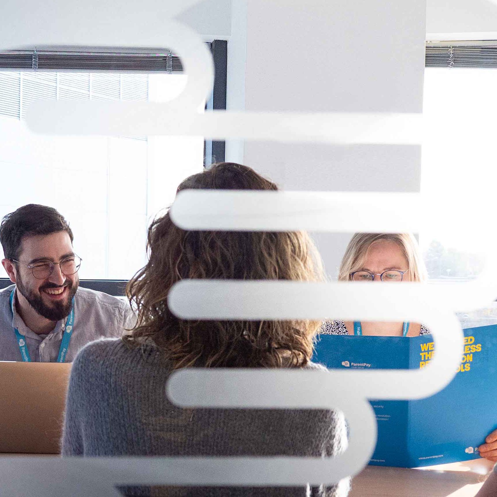 Meeting in a glass windowed board room.