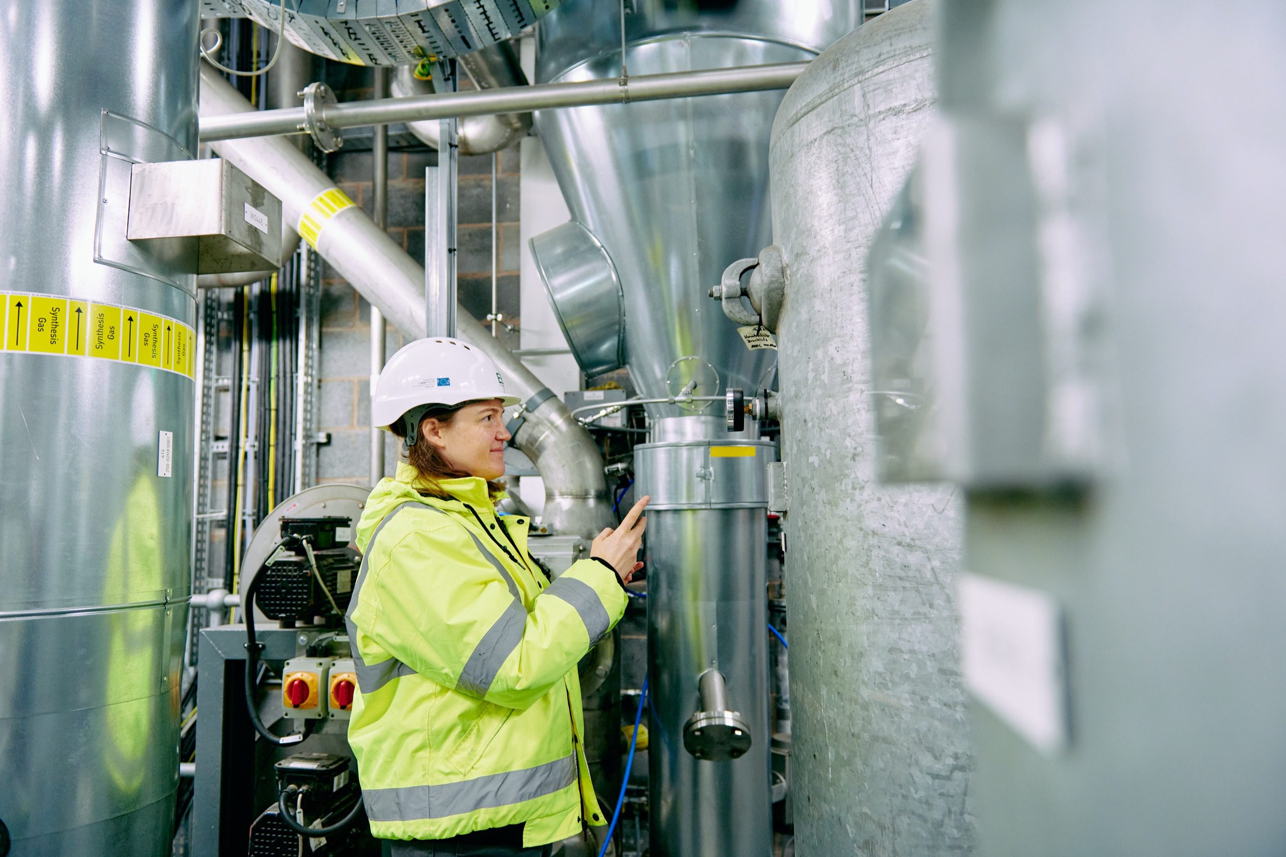 Engineer examining dials on machinery.