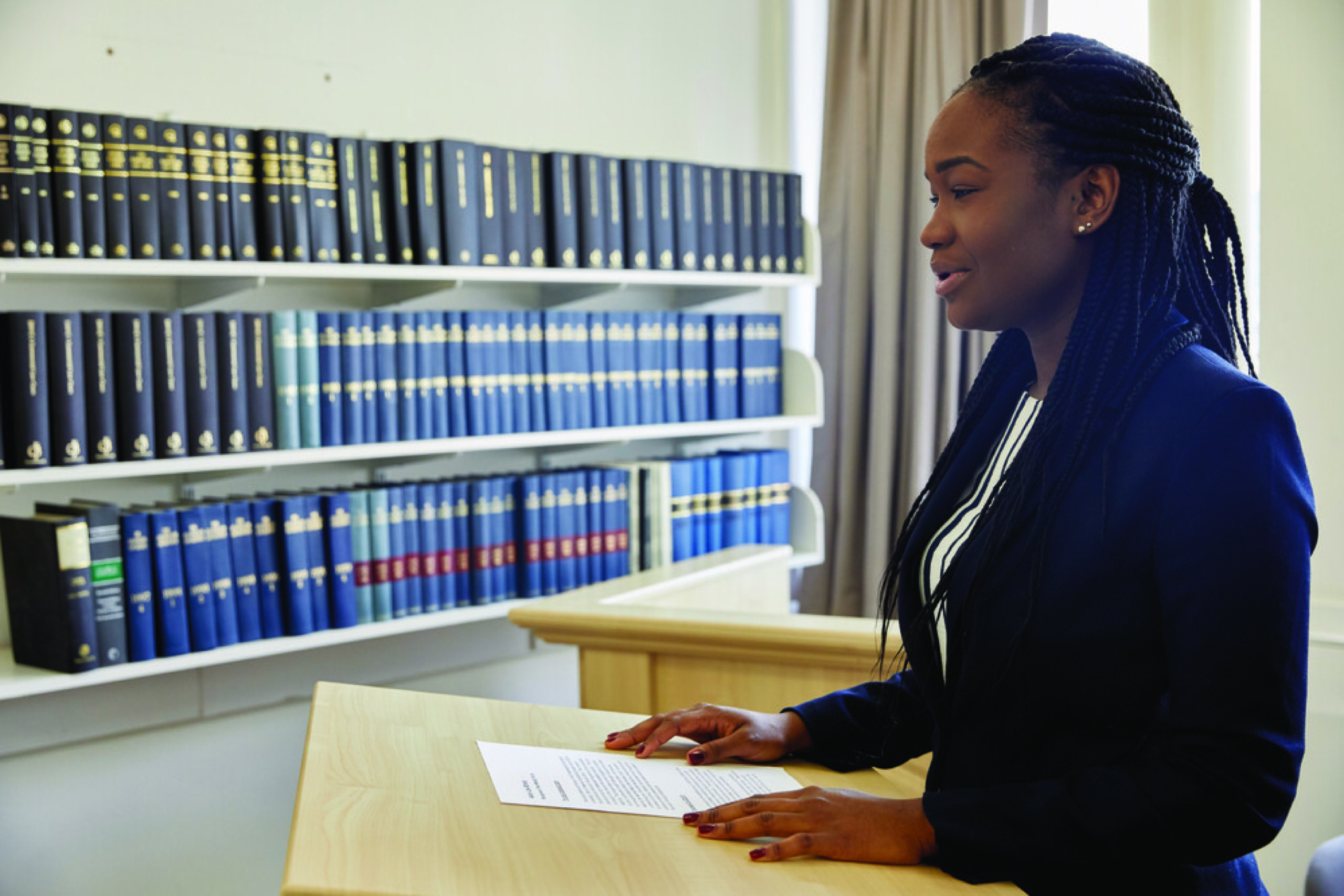 Law student giving a speech at a podium.