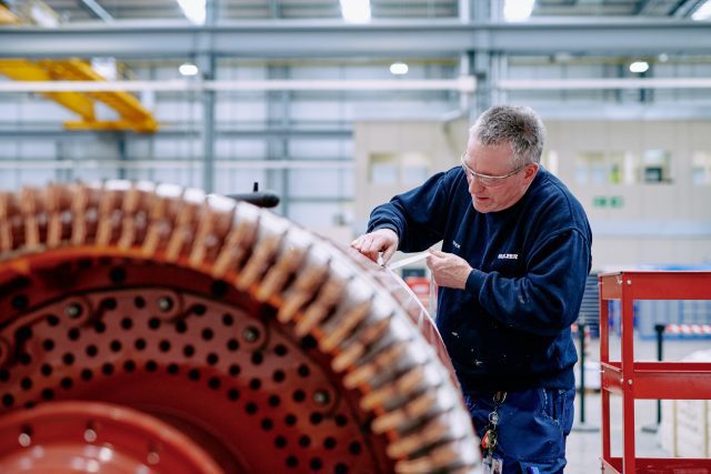 Engineer making replacement coil for a turbine engine.