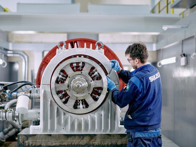 Engineer servicing coil on turbine.