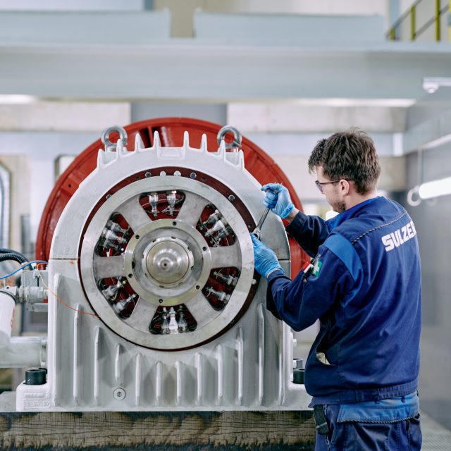 Engineer servicing coil on turbine.