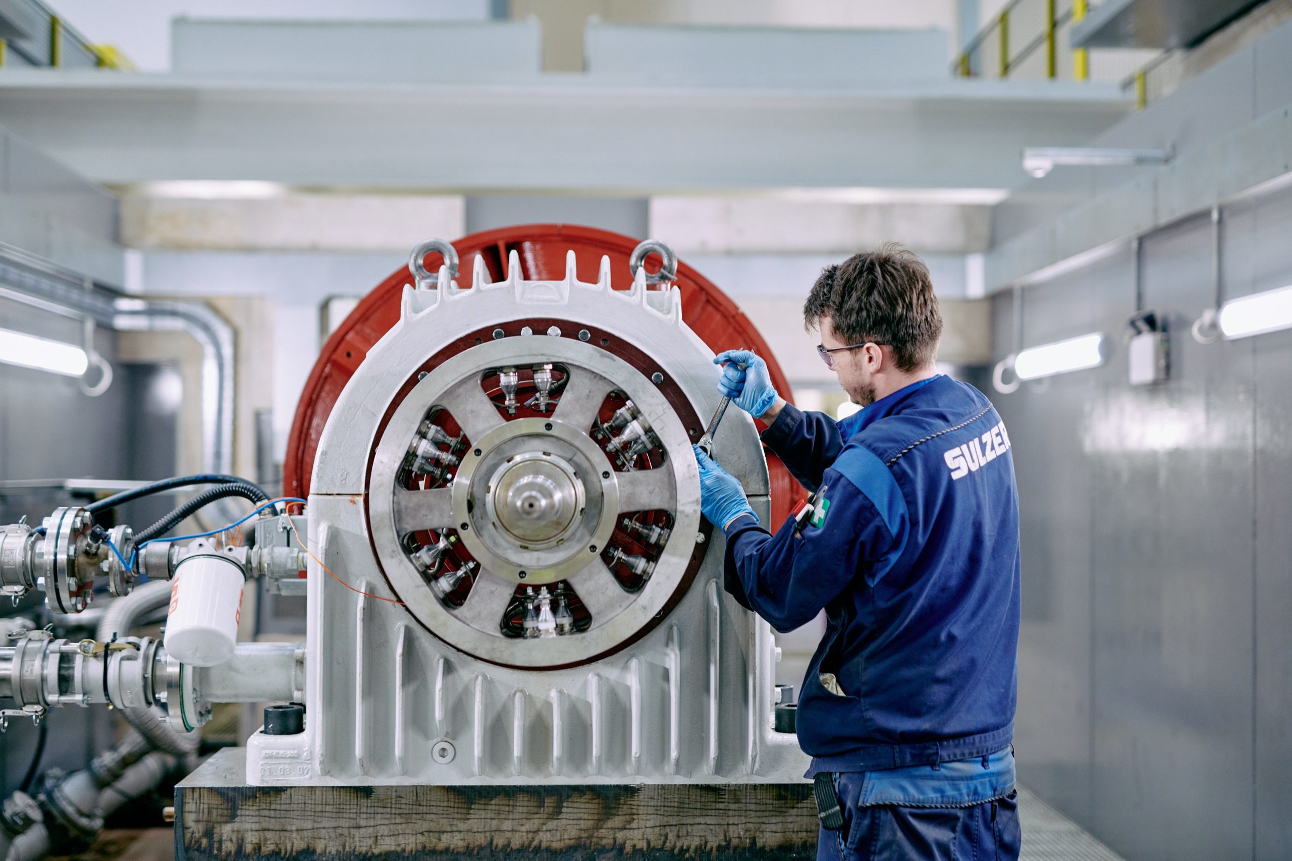 Engineer servicing coil on turbine.