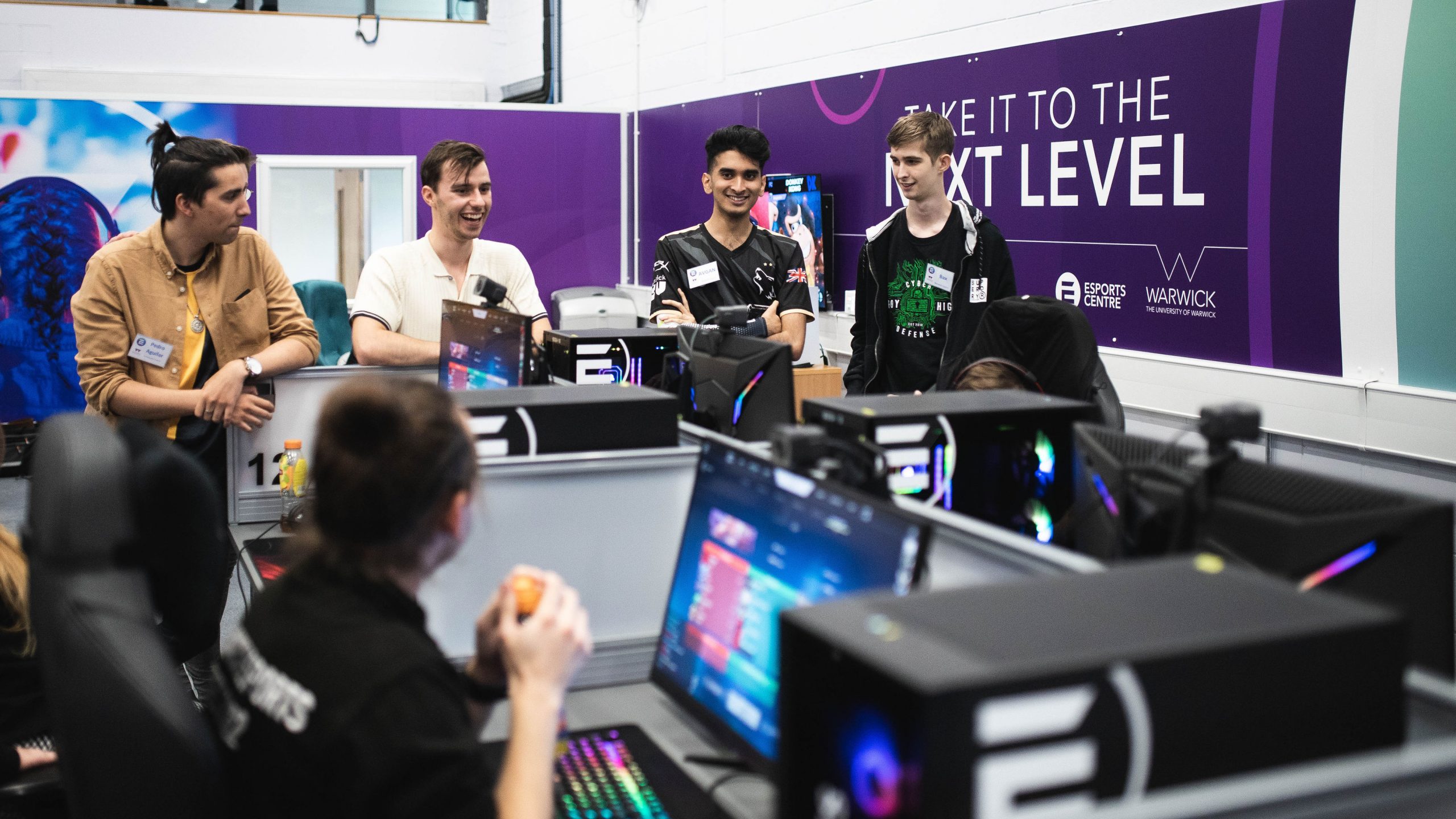 People in gaming t-shirts in an esports centre.