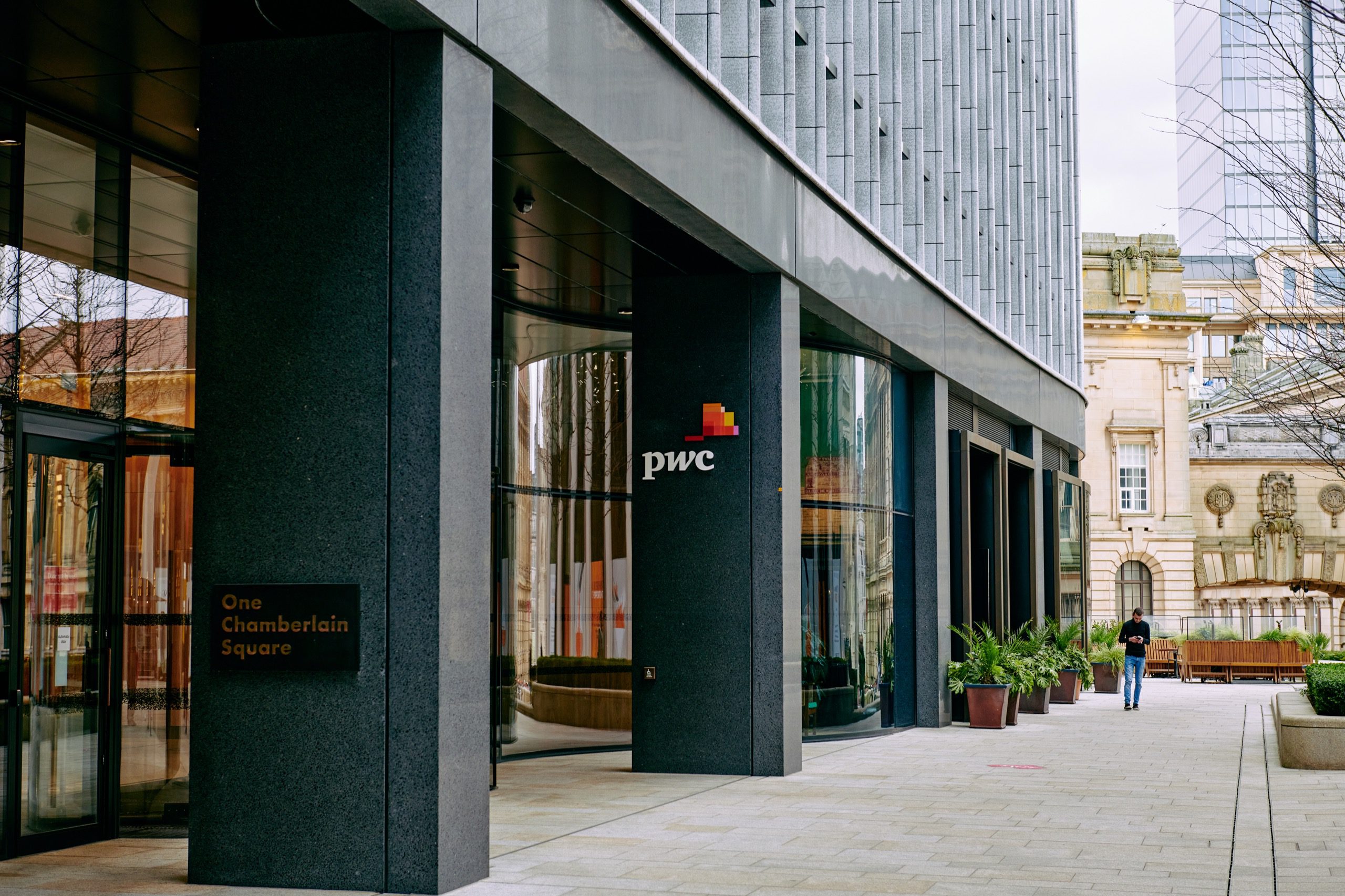 Entrance to One Chamberlain Square, Paradise Birmingham. The PricewaterhouseCoopers (PwC) logo is visible on a column.