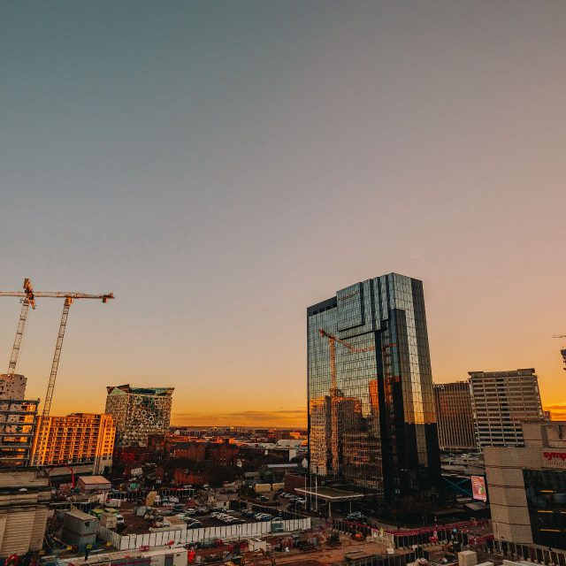 Birmingham skyline looking across Arena Central development and The Cube with the sun setting in the background.