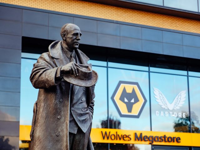Statue of man at Wolves football ground.