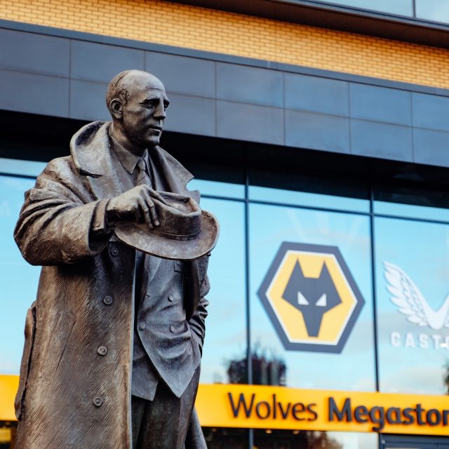 Statue of man at Wolves football ground.