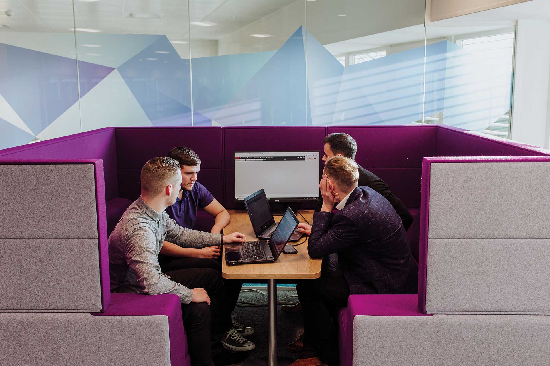 People meeting in a breakout seating area.