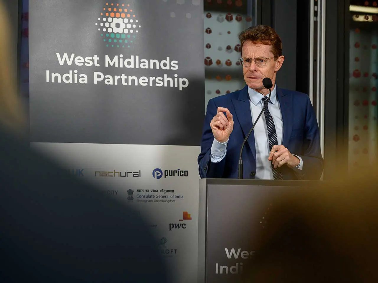 Andy Street speaking at a podium with the text 'West Midlands India Partnership'.