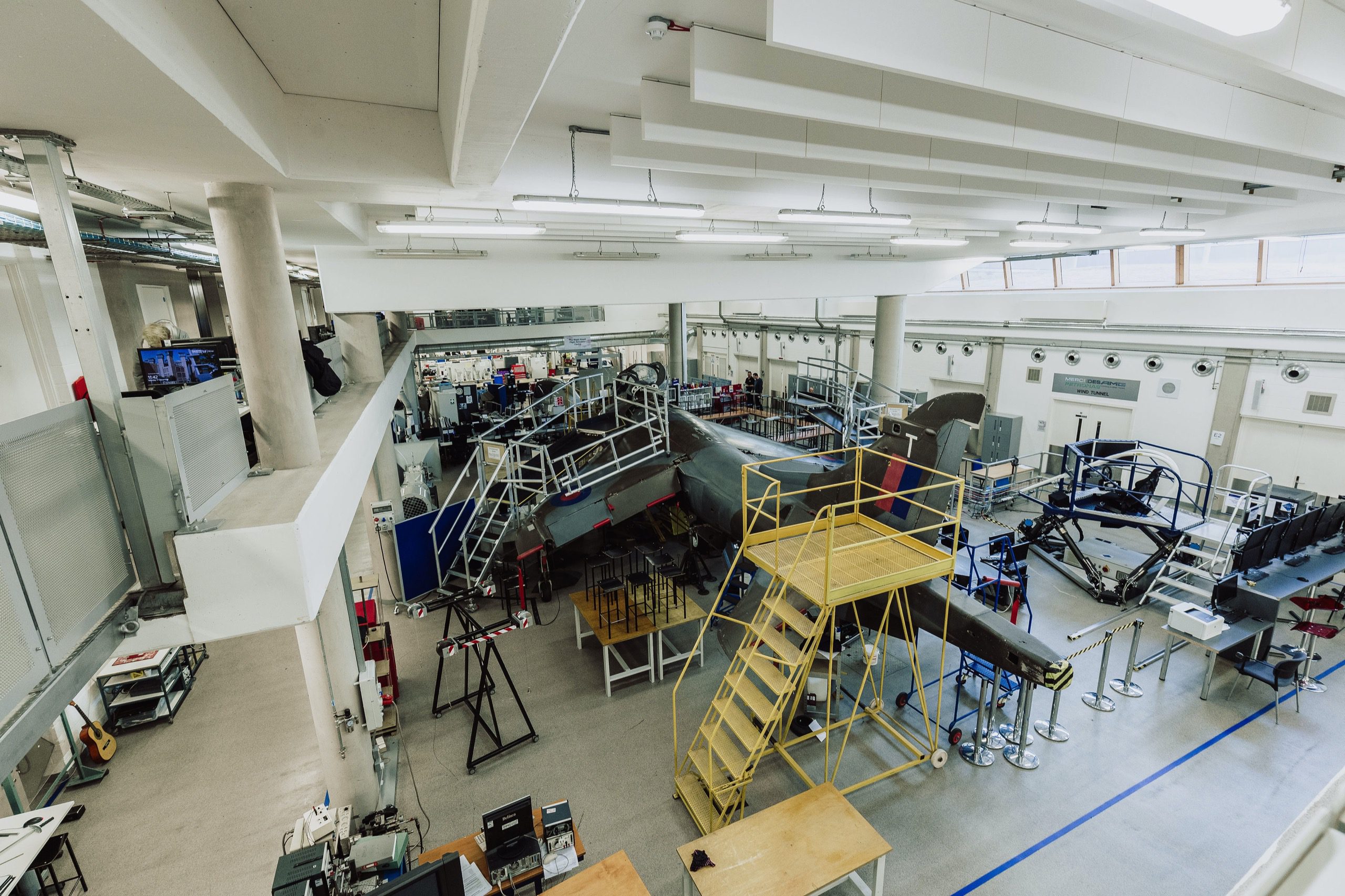 A life size plane with various gantries and stairs around it. Flight simulator at Coventry University.