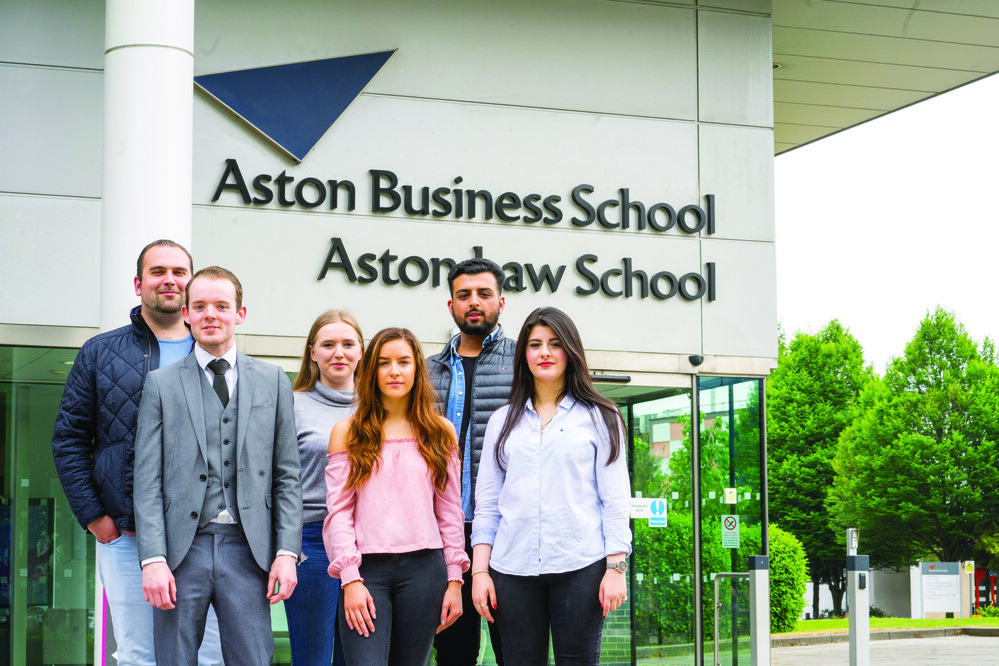 Aston Law School entrance with students standing outside.