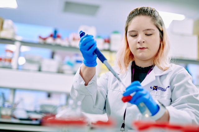 Students testing Cancer cells with a pipette.