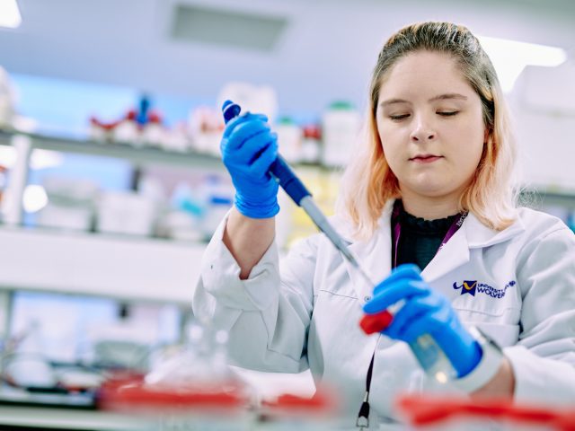 Students testing Cancer cells with a pipette.