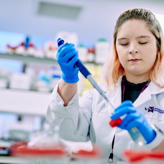 Students testing Cancer cells with a pipette.