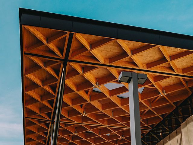 An awning with decorative cross beams forming a repeating diamond pattern.