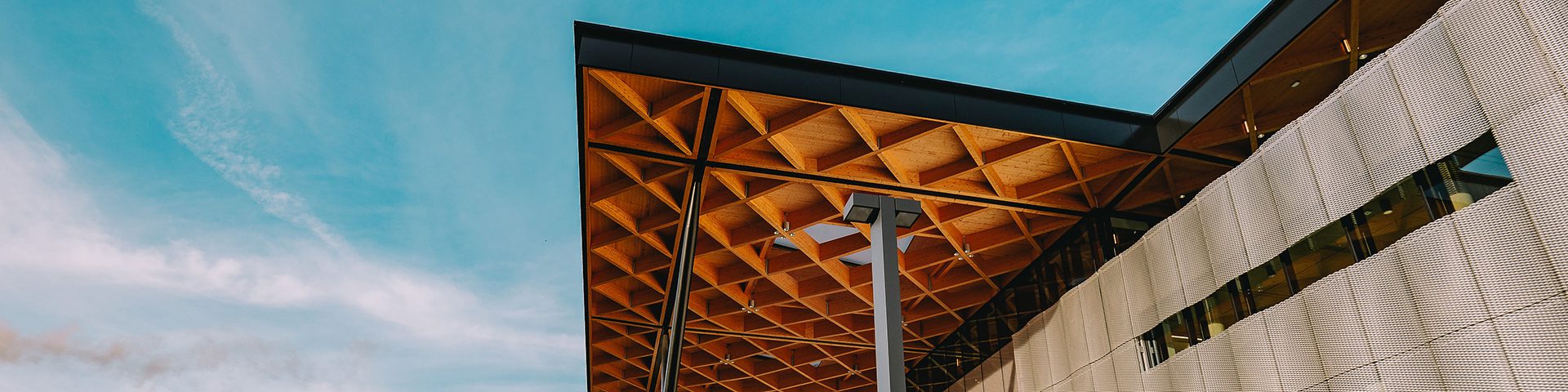 An awning with decorative cross beams forming a repeating diamond pattern.