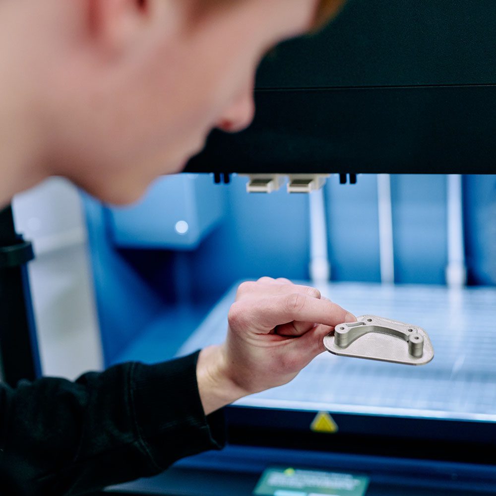 Inspecting a machined metal part.