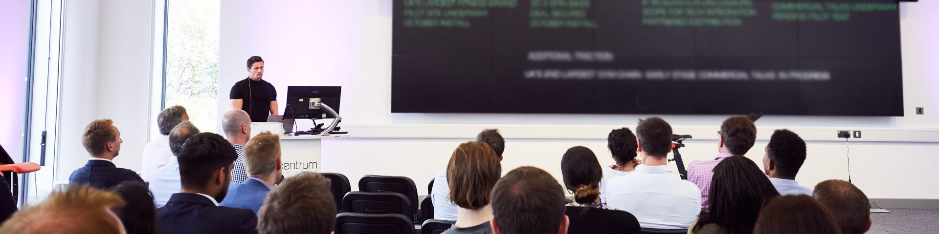 Event with a key speaker talking to a conference room.