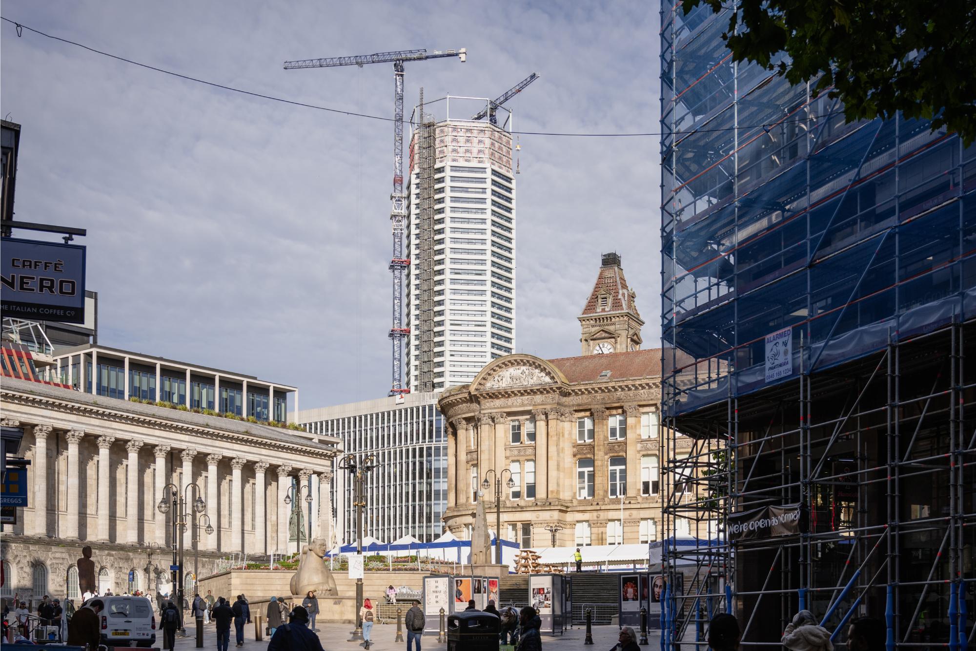 The Octagon building seen from Victoria Square with cranes finishing the final touches to the roof.