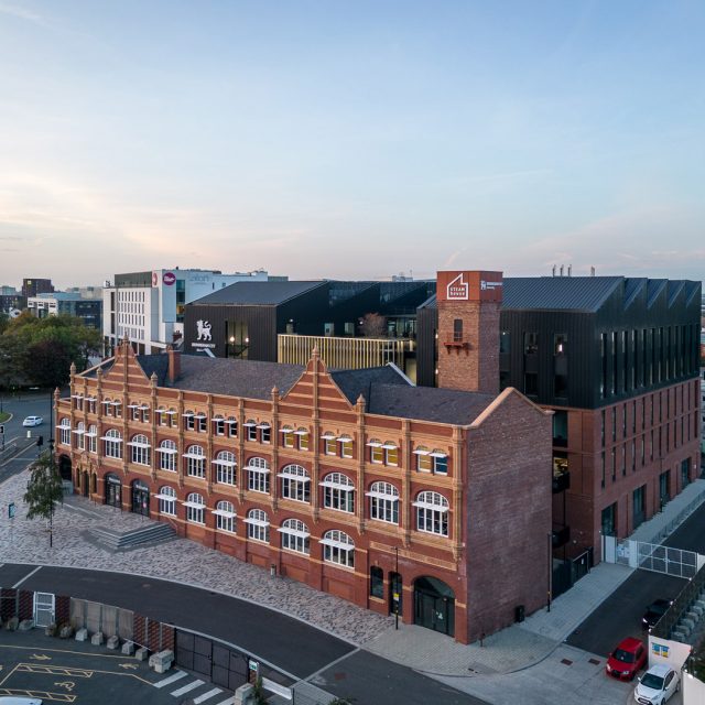 STEAMhouse, seen from a high angle, with its iconic chimney-like tower.