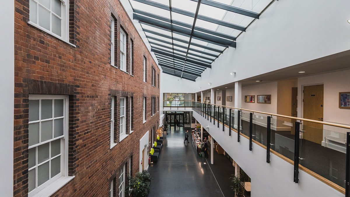 The interior of a building worked on by Constructing West Midlands with classic brickwork on the left and a more modern design on the right.